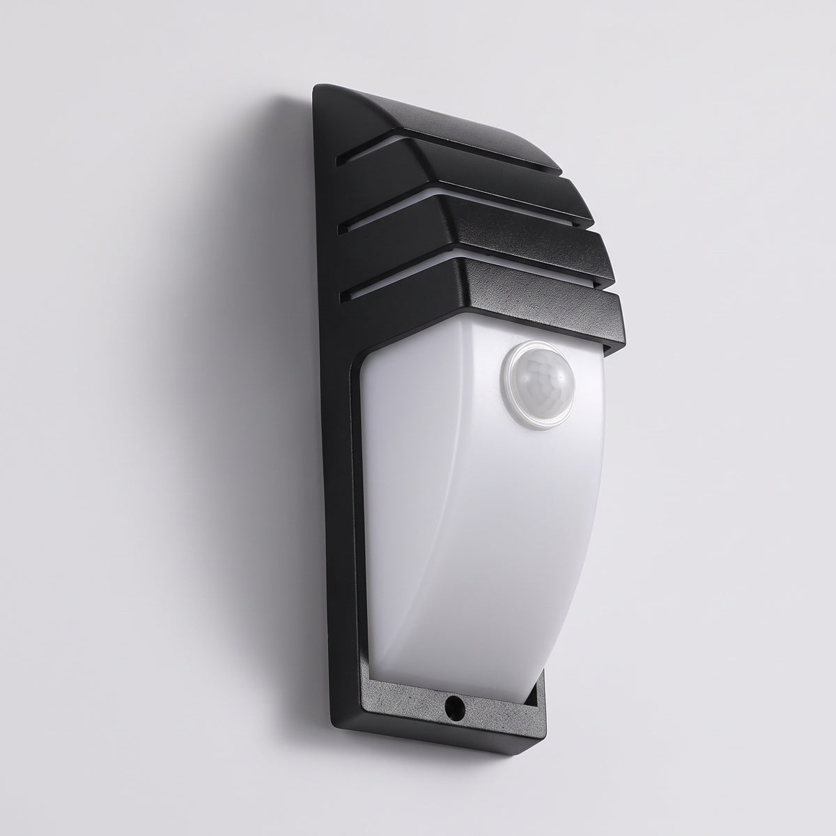 Strata black outdoor wall light with radar motion sensor lens on a grey studio background