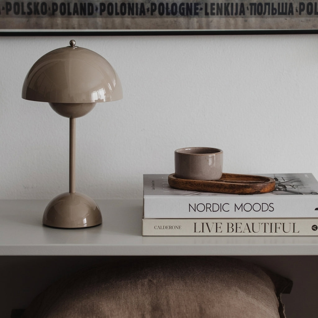 grey sulba lamp on a shelf with books and a cup in a minimalistic setting