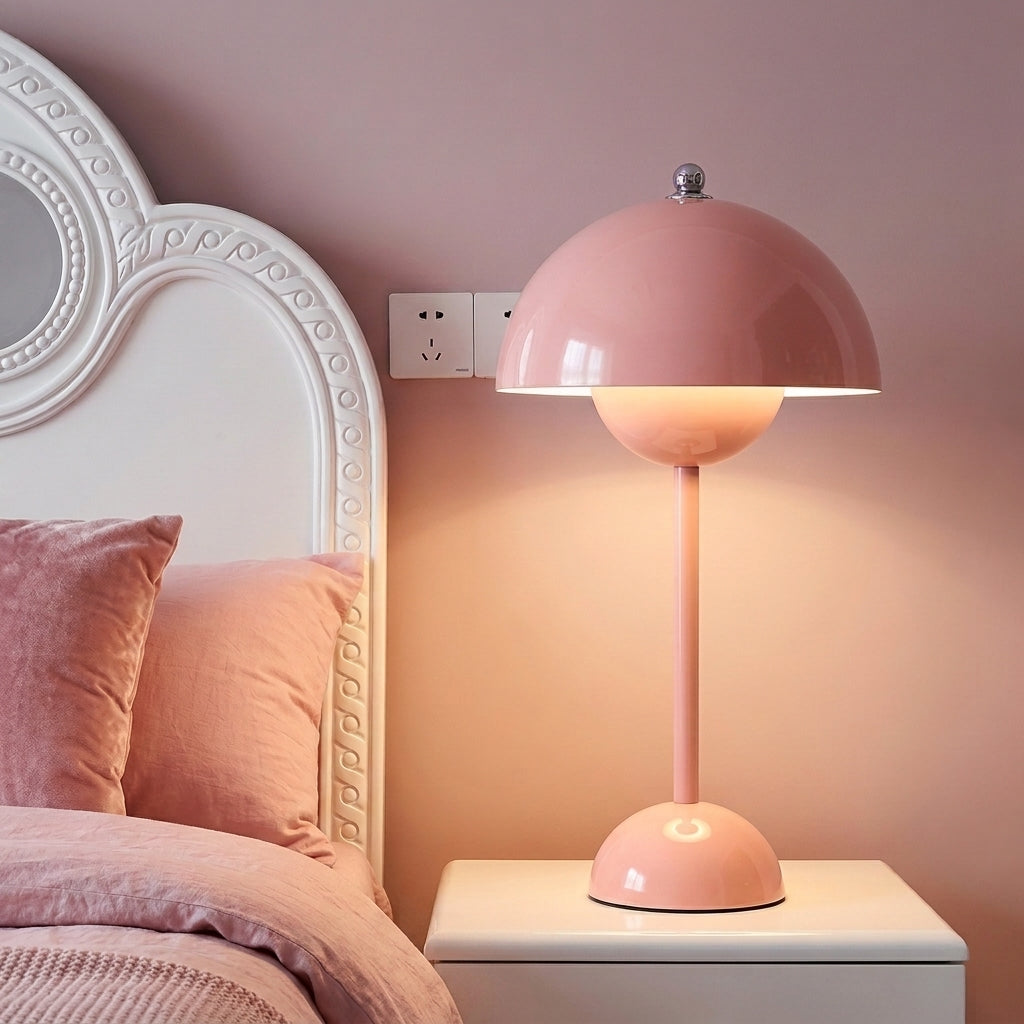 Pink sulba macaron cordless bedside reading lamp casting a warm, romantic glow next to a white bed frame