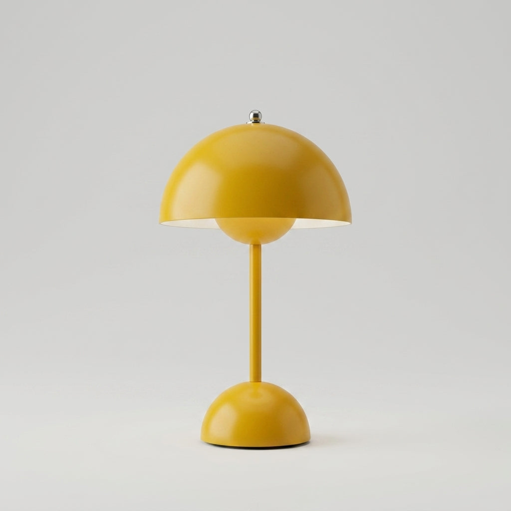 A modern sulba mushroom-shaped table lamp in a glossy mustard yellow finish, featuring a dome-shaped shade, a slim central stem, and a matching dome base on a light gray background.