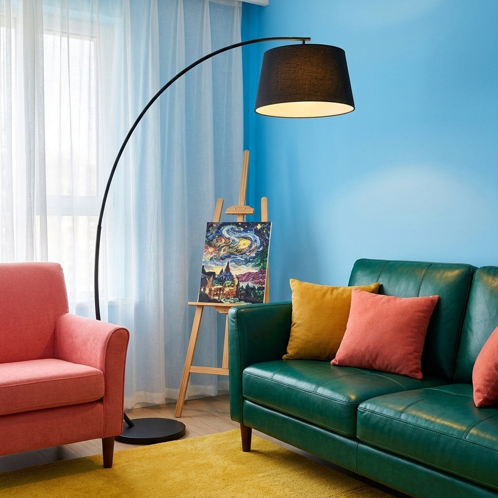 Tavio arc floor lamp rising behind an emerald green leather sofa with a bright yellow rug