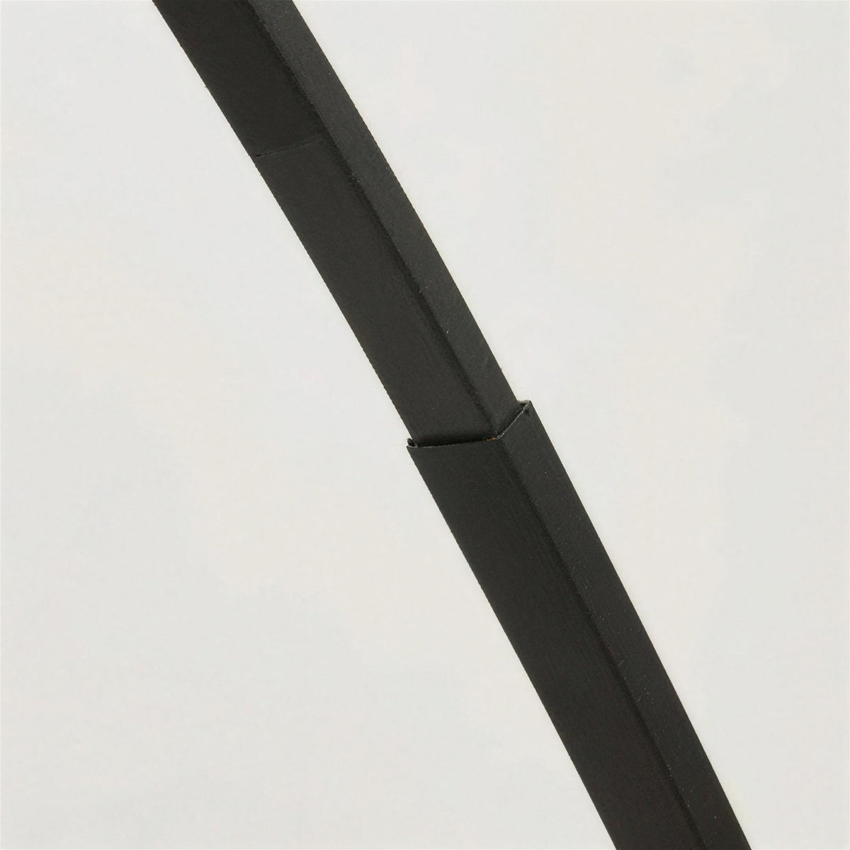 Close-up of the Tavio arc floor lamp telescopic arm joint
