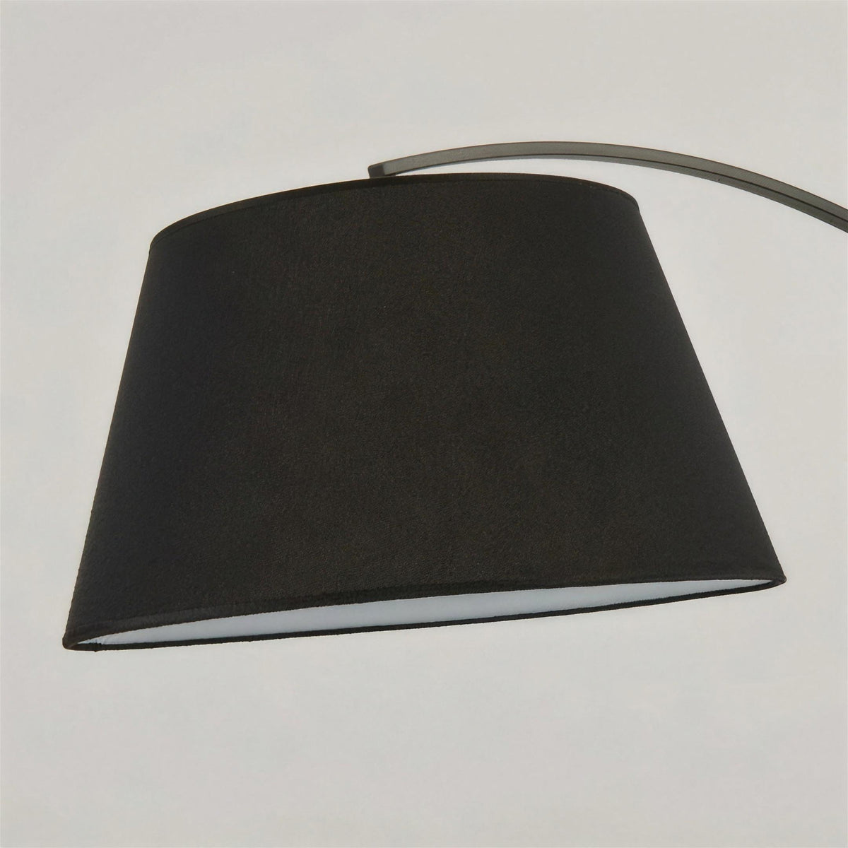 Close-up of the Tavio arc floor lamp black fabric drum shade