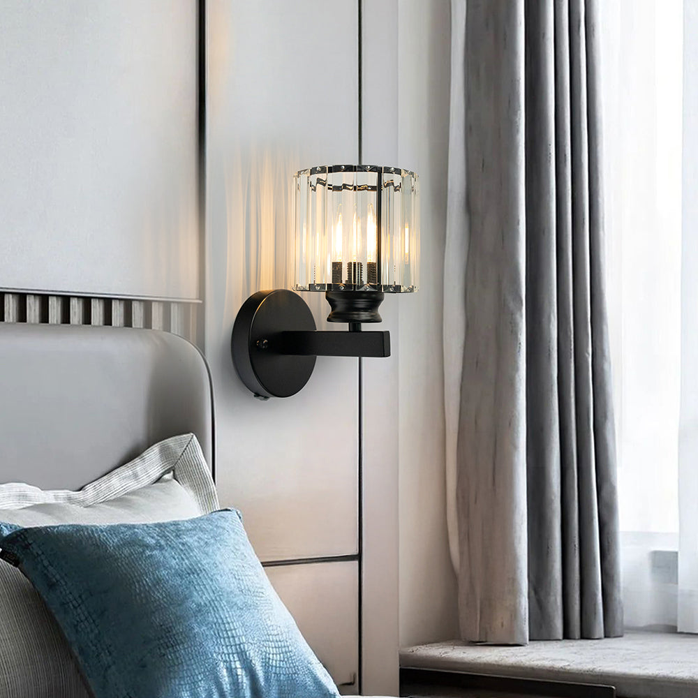 Black teja round crystal wall sconce installed as elegant bedside lighting next to a headboard