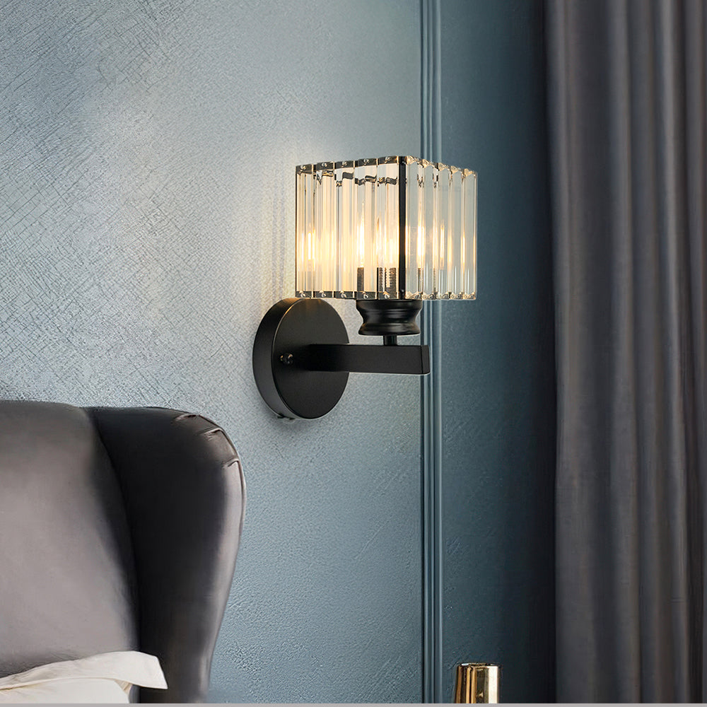 Black teja square crystal wall sconce contrasting beautifully against a moody dark blue interior wall