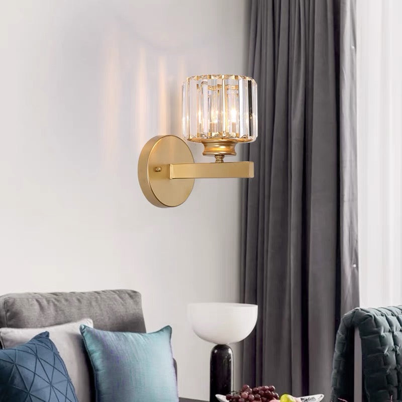 Gold teja round crystal wall lamp mounted in a modern, naturally lit living space