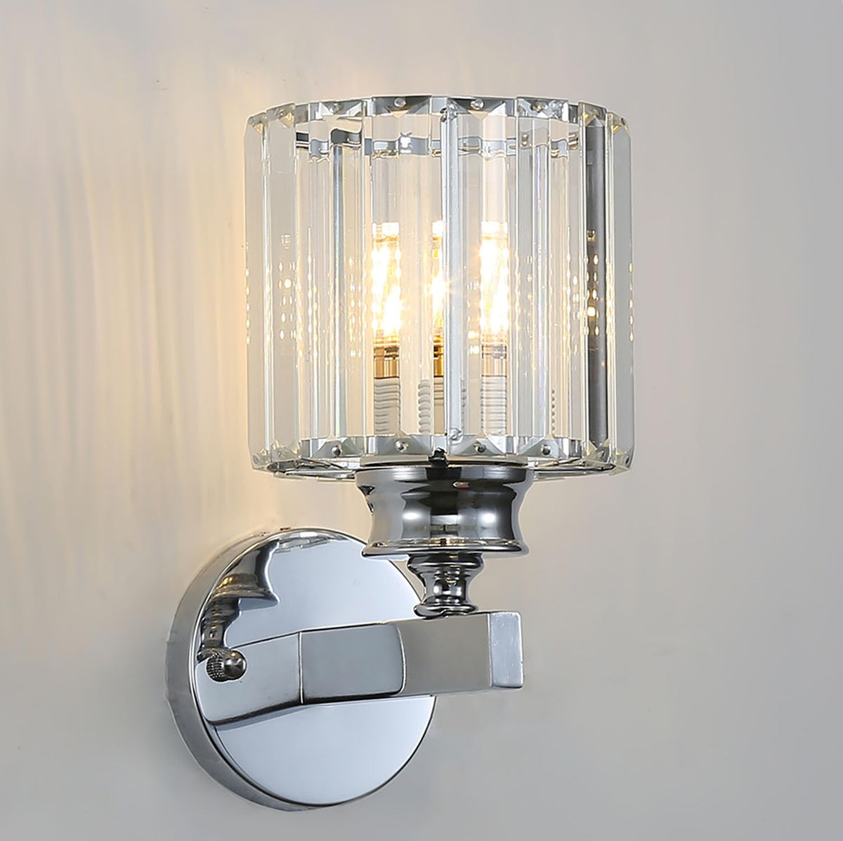 Modern teja silver round crystal wall sconce isolated against a neutral grey background