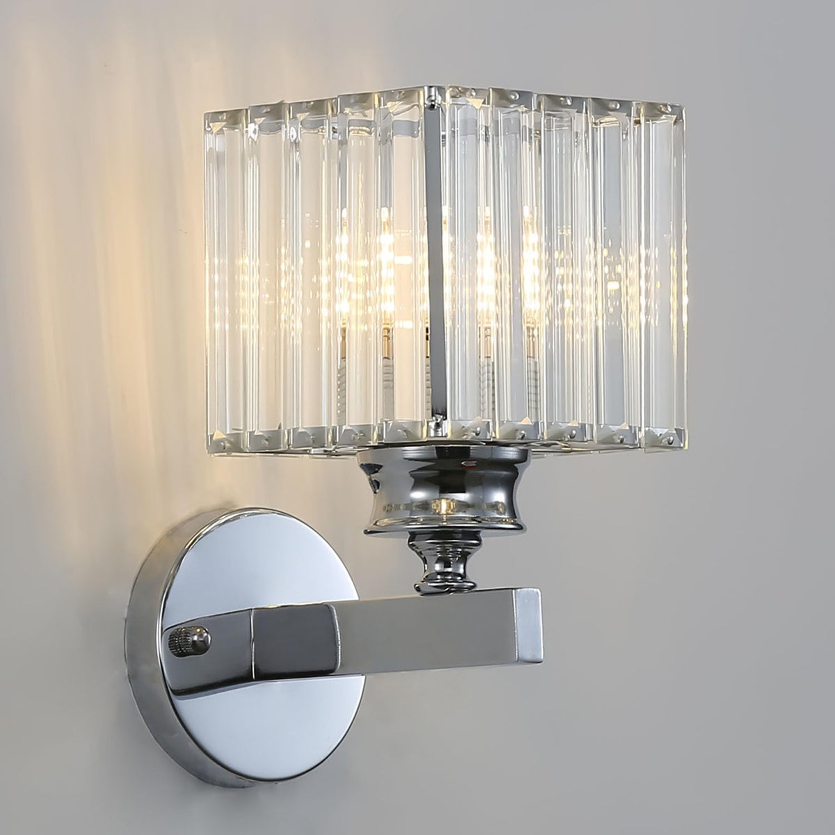 Sleek silver teja square crystal wall light isolated against a neutral grey background