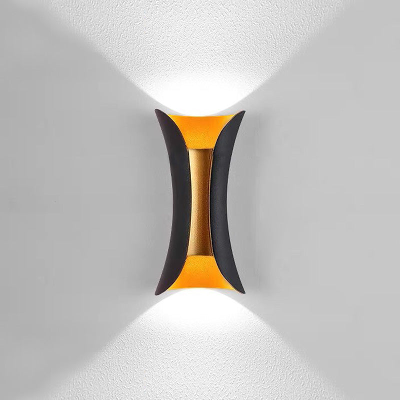 Front view of the teka illuminated black and gold two-tone architectural outdoor sconce