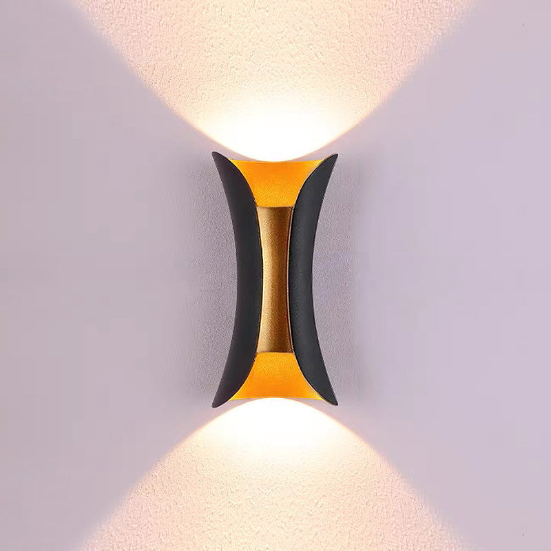 Black and gold teka architectural wall washing light with a distinct pinched centre silhouette