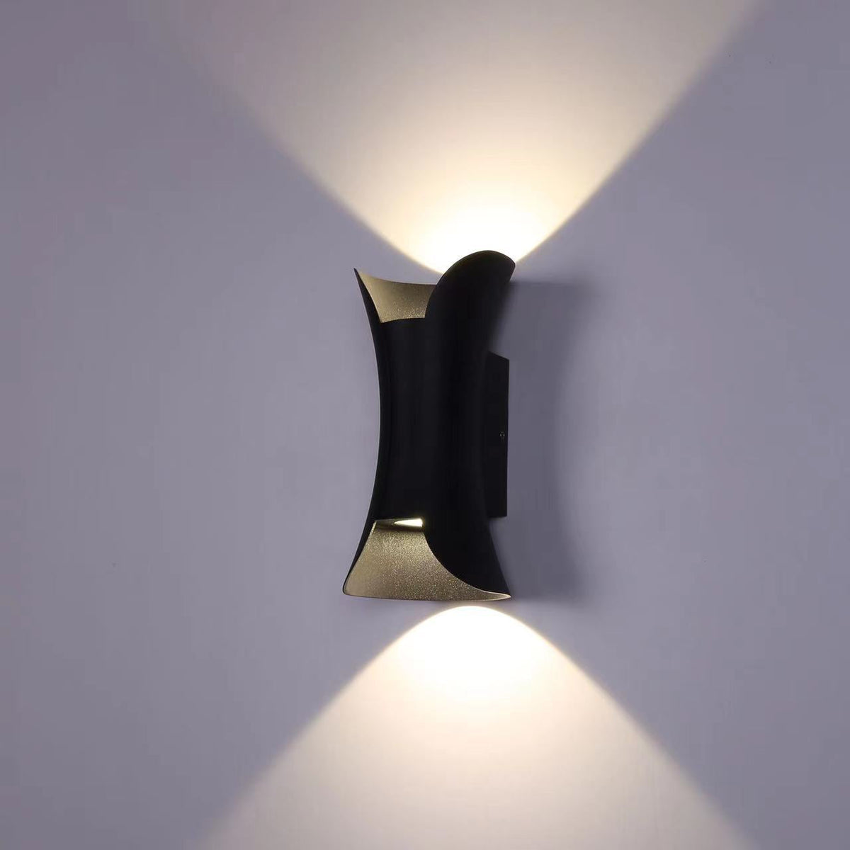 Angled side profile of teka curved black and gold exterior wall lamp