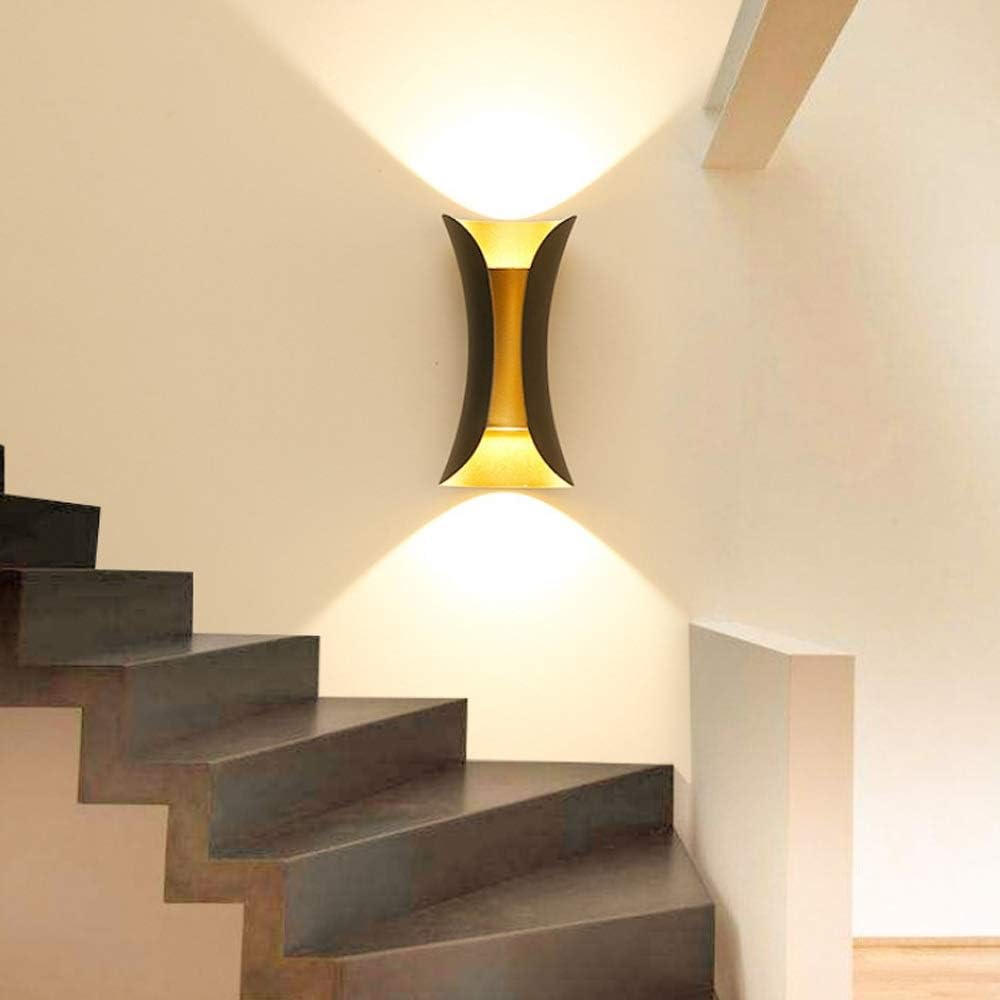 Modern teka hourglass wall light used indoors to illuminate a contemporary wooden staircase