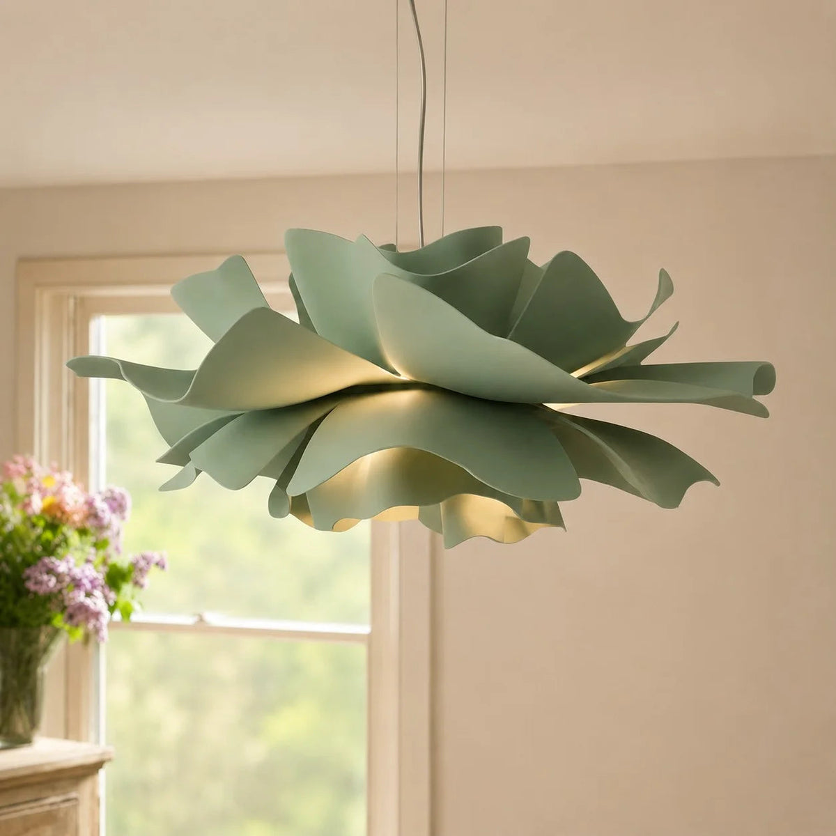 Sage green telba lotus flower ceiling lamp hanging in a bright, naturally lit room