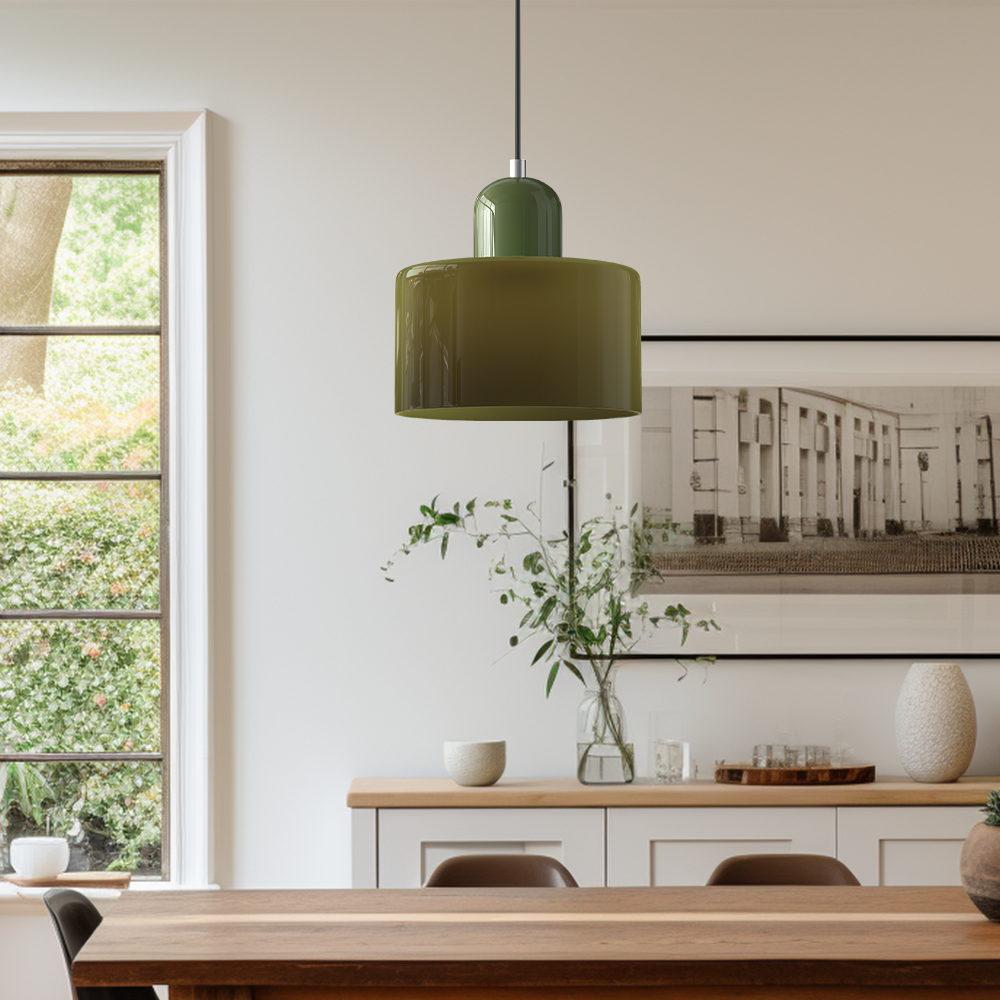 Green Bauhaus tepa glass pendant illuminating a minimalist wooden dining table setup