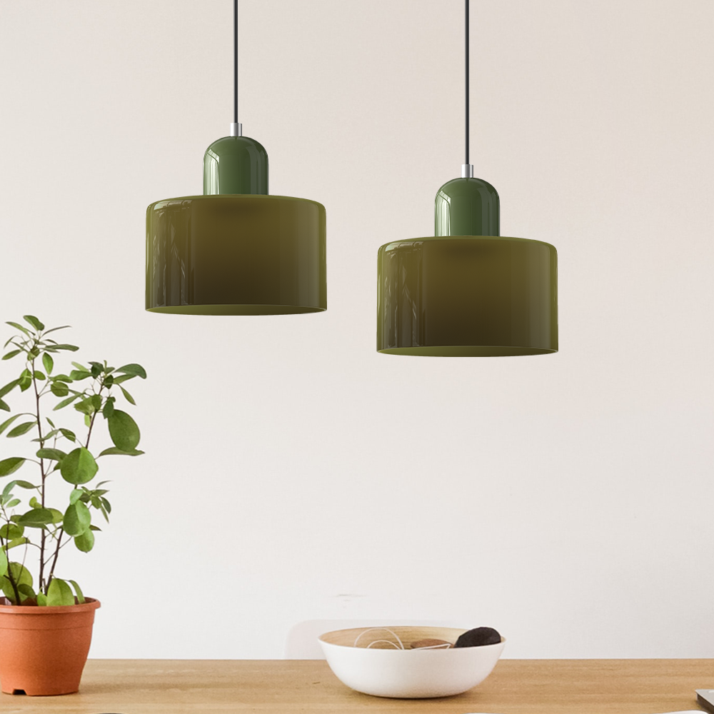 Pair of green Bauhaus tepa glass pendant lights with warm ambient illumination