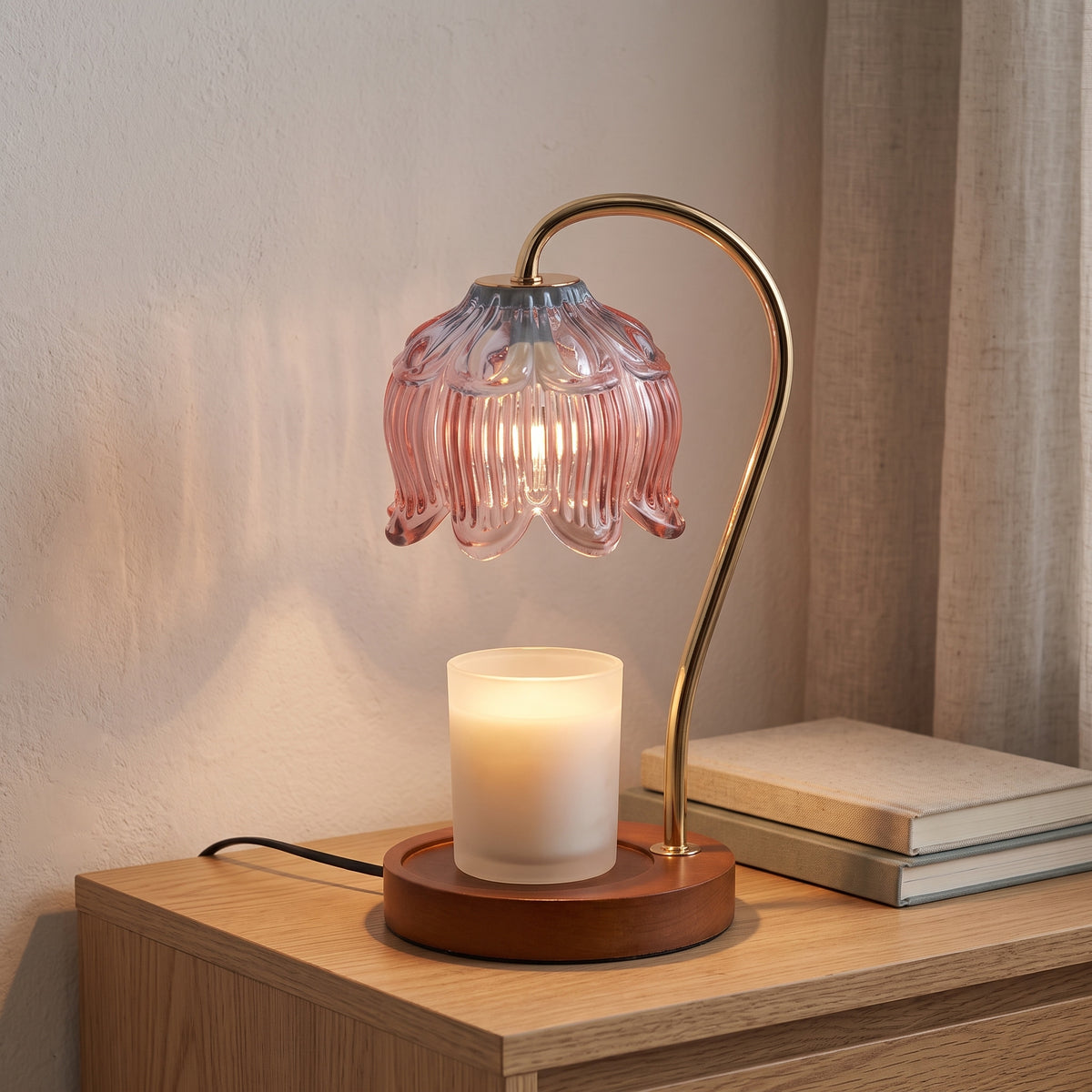 Tulvi pink glass tulip candle warmer lamp with a gold-finish arm and wooden base, warming a candle jar