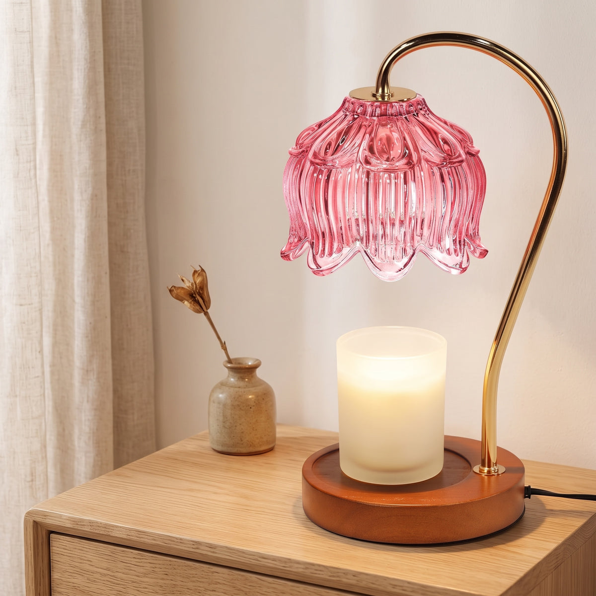 Tulvi pink glass tulip candle warmer lamp on a wooden table