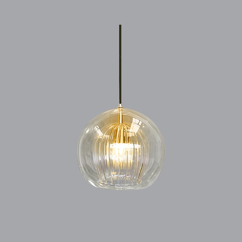 Illuminated clear double-layer tuoj glass pendant highlighting the warm glow of its fluted inner shade