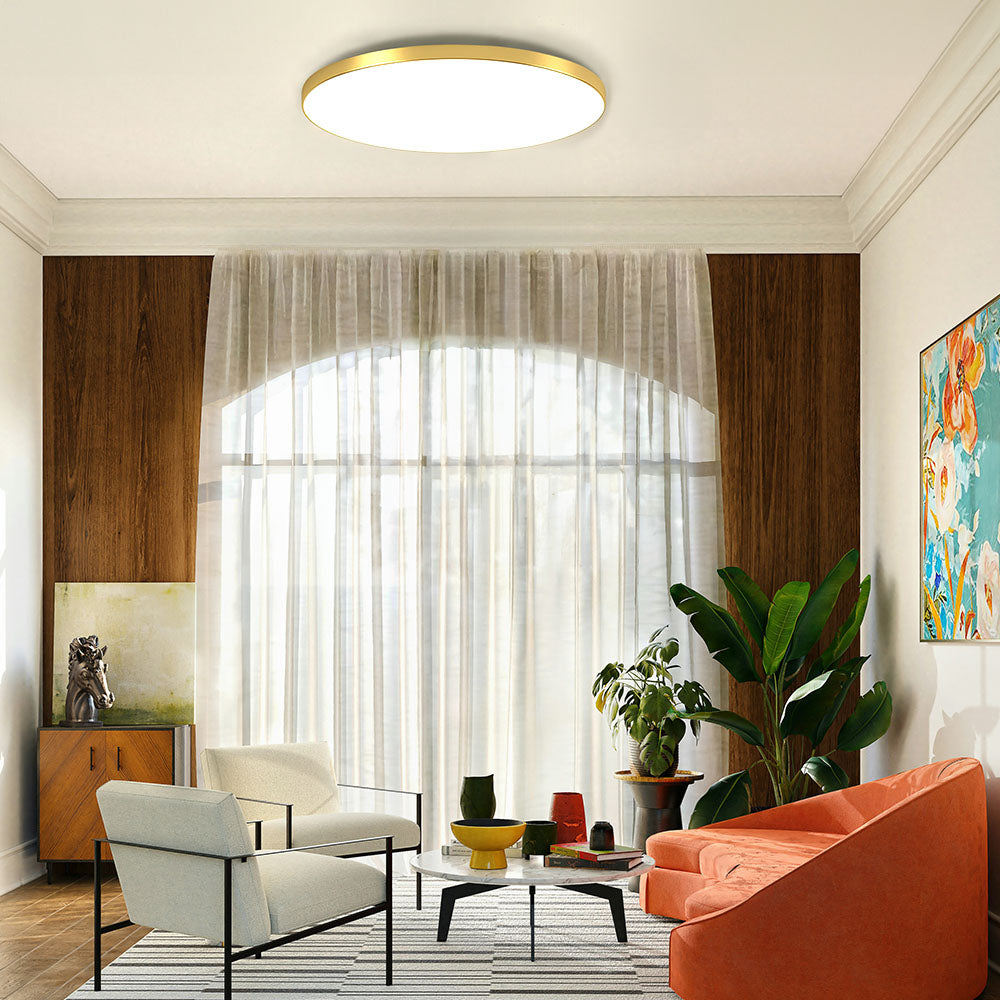 Minimalist gold round flush mount tywa ceiling light providing bright ambient lighting in a warm living room