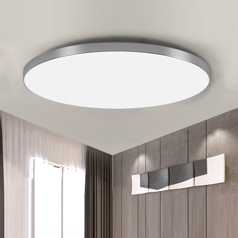Ultra-thin silver modern round LED flush mount tywa ceiling lamp isolated against a white ceiling
