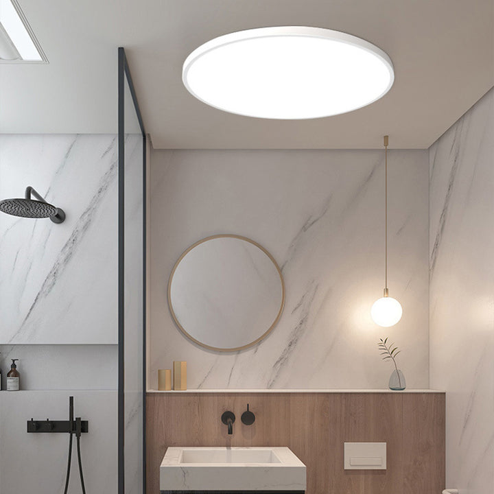Ultra-thin white flat panel LED tywa ceiling light installed in a sleek, modern washroom interior