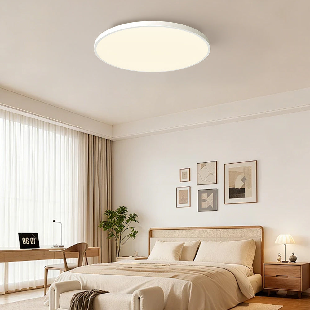 White minimalist flush mount tywa ceiling light illuminating a bright home office and bedroom space