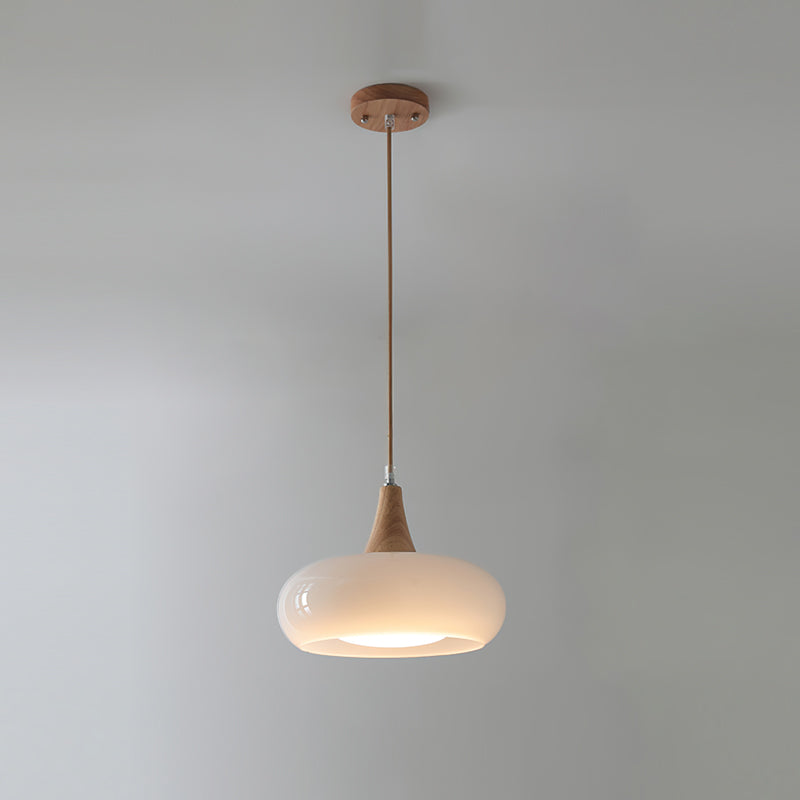 Single utul white Nordic glass and wood dome pendant isolated against a light grey wall