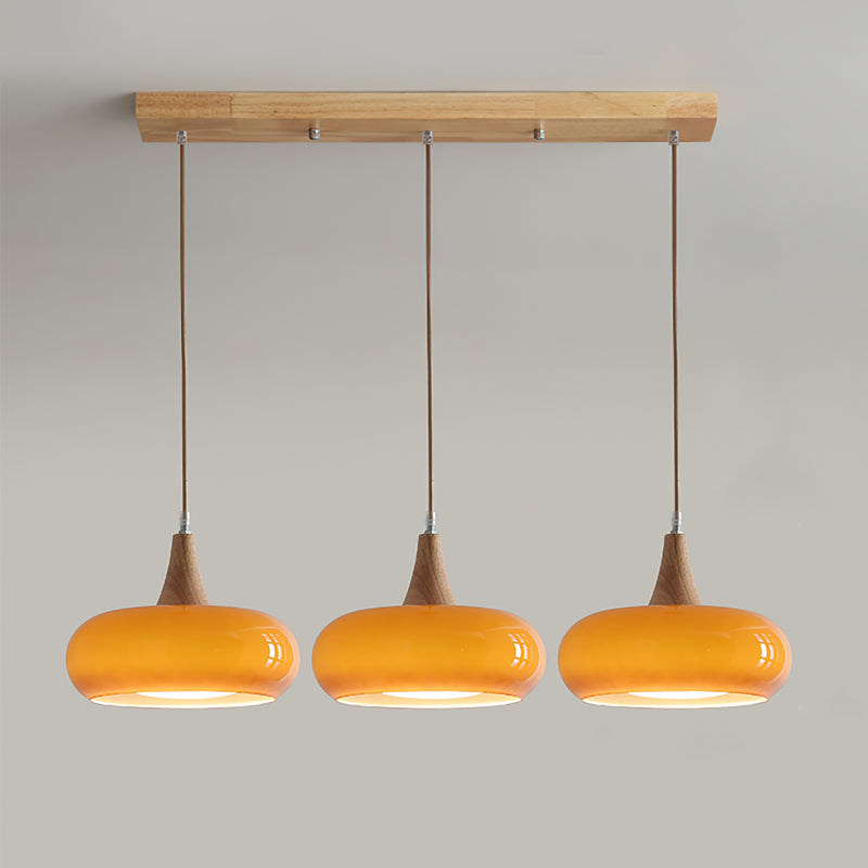 3-head utul orange mid-century linear light fixture perfectly spaced for a kitchen island