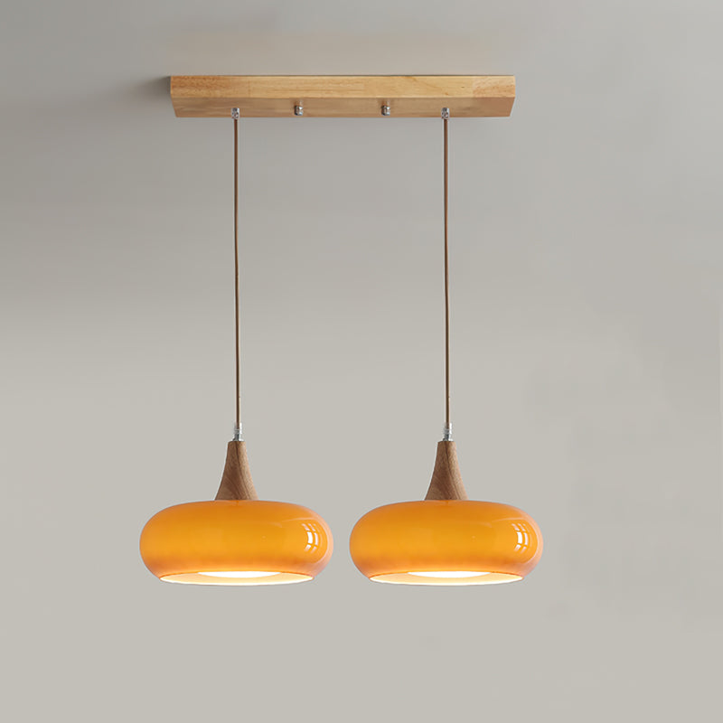 2-head orange utul linear glass pendant light isolated on a neutral background
