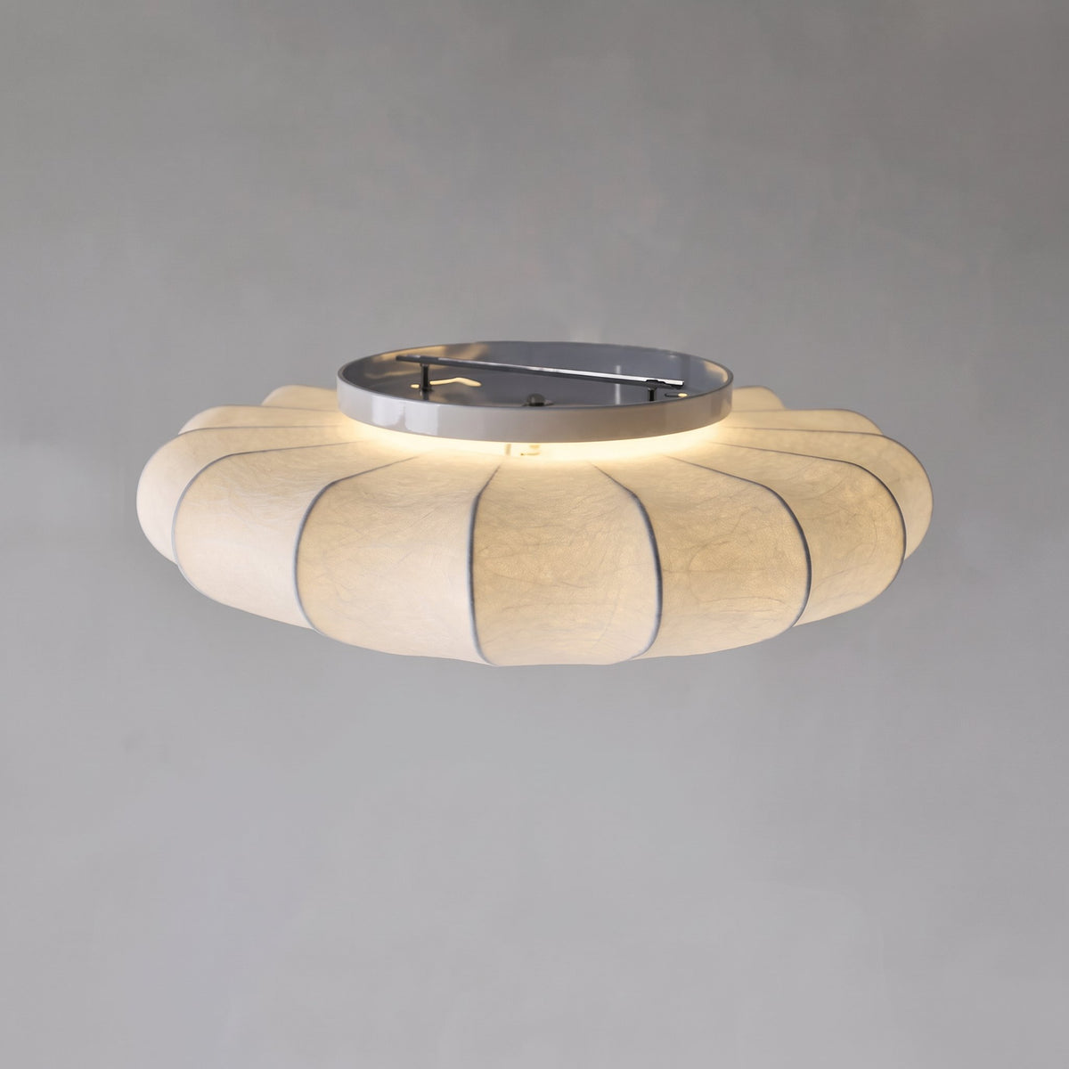 Varly silk ceiling light switched on showing the silk shade and metal base