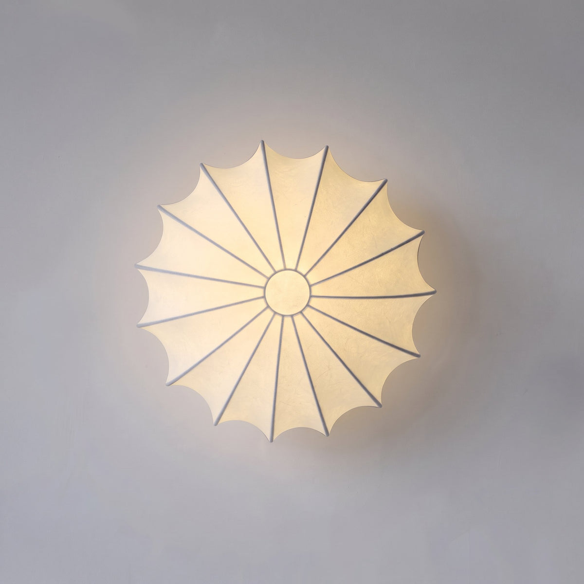 View from below of the Varly silk ceiling light switched on showing the ribbed panels