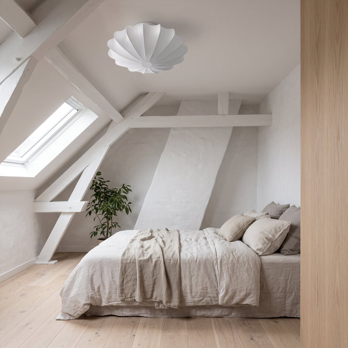 Varly white silk ceiling light in a loft conversion bedroom with a skylight