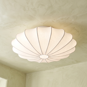 Varly white silk flush mount ceiling light with ribbed panels on a plastered ceiling