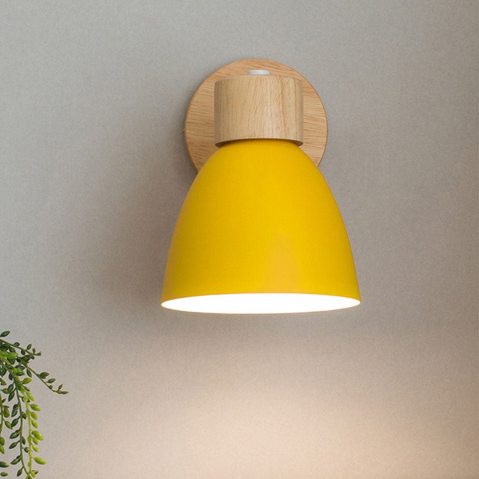 Front view of the yellow vexol Nordic wall lamp casting a warm downward glow against a plain wall