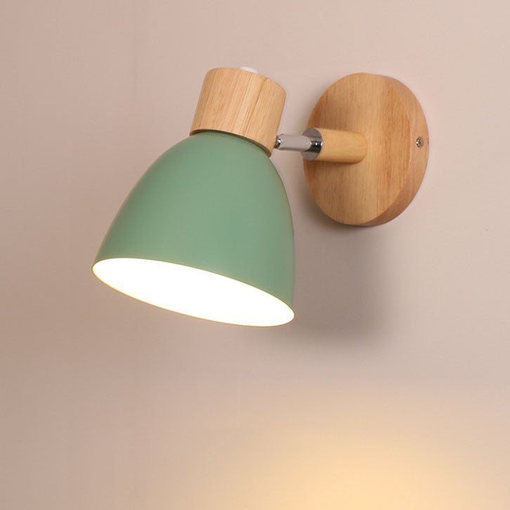 Green vexol Nordic metal and wood wall sconce without a pull cord casting a warm downward glow