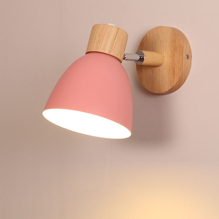 Pink macaron vexol bedroom sconce highlighting its smooth metal shade and natural wooden bracket