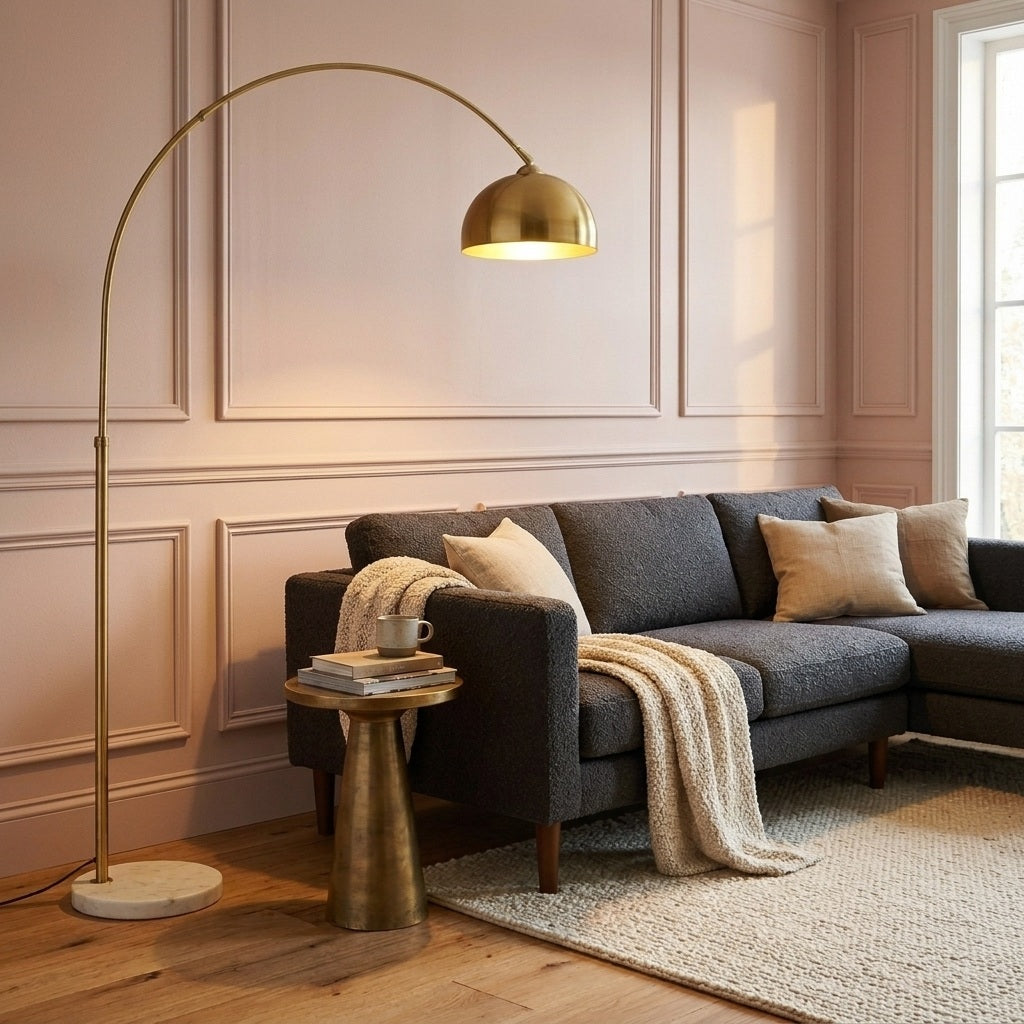 Gold arc floor lamp in a blush pink room