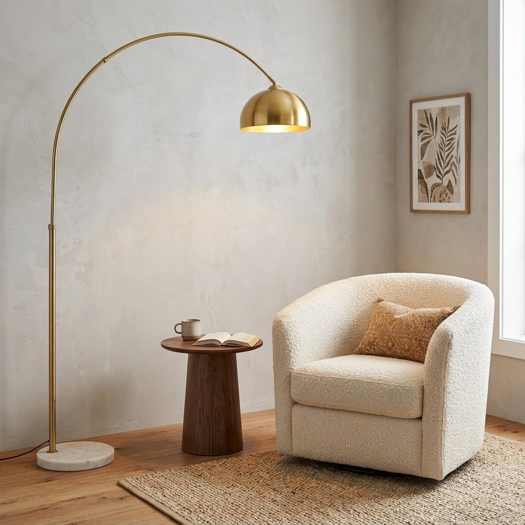 Gold arc floor lamp arching over an armchair in a reading nook