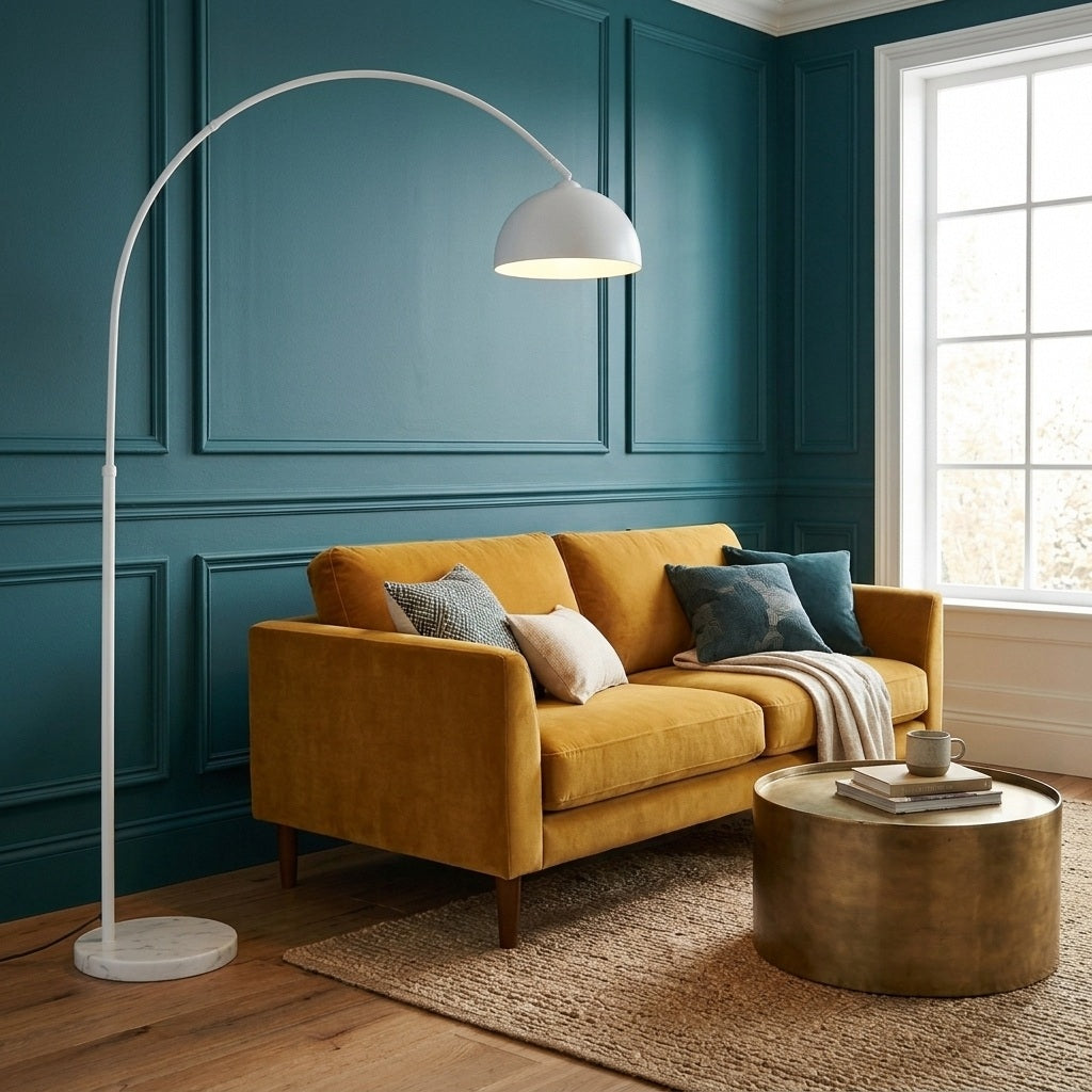 White arc floor lamp beside a sofa in a living room with teal accents