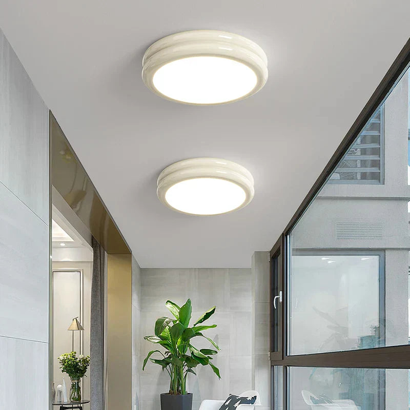 Milky white minimalist flush mount vyter ceiling lights glowing warmly in a contemporary living space