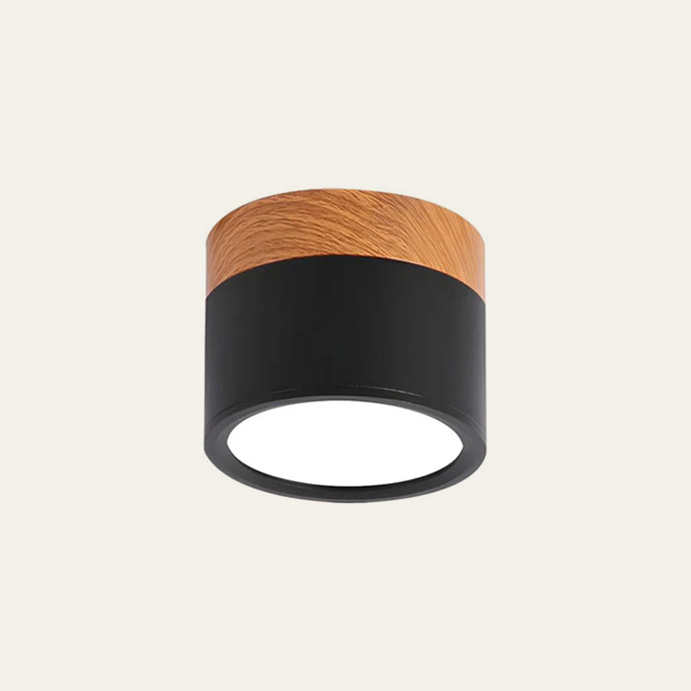 Close-up of a matte black aluminium cylinder flush vytri ceiling light with wood-effect trim