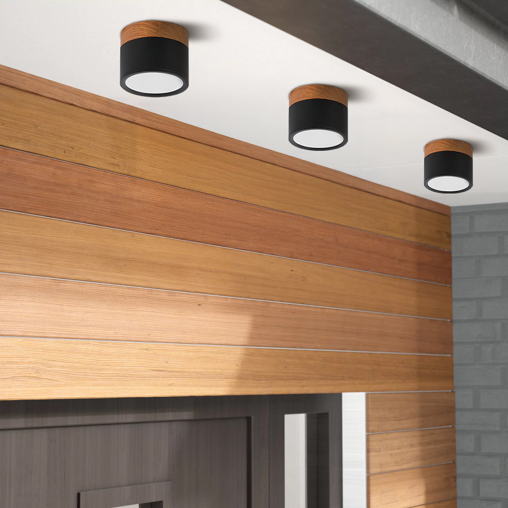 Black cylinder surface-mounted vytri spotlights installed on a modern ceiling