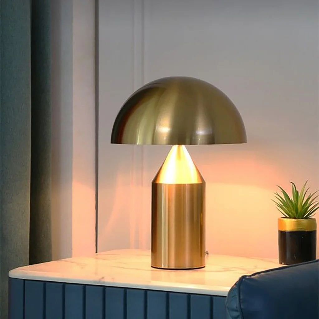 Gold Bauhaus wesk mushroom lamp resting elegantly on a dark blue living room sideboard