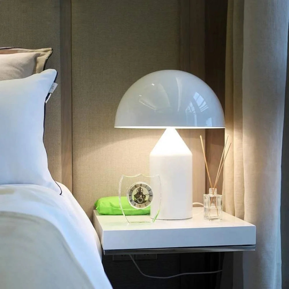 Modern wesk white mushroom table lamp illuminating a sleek contemporary bedside table