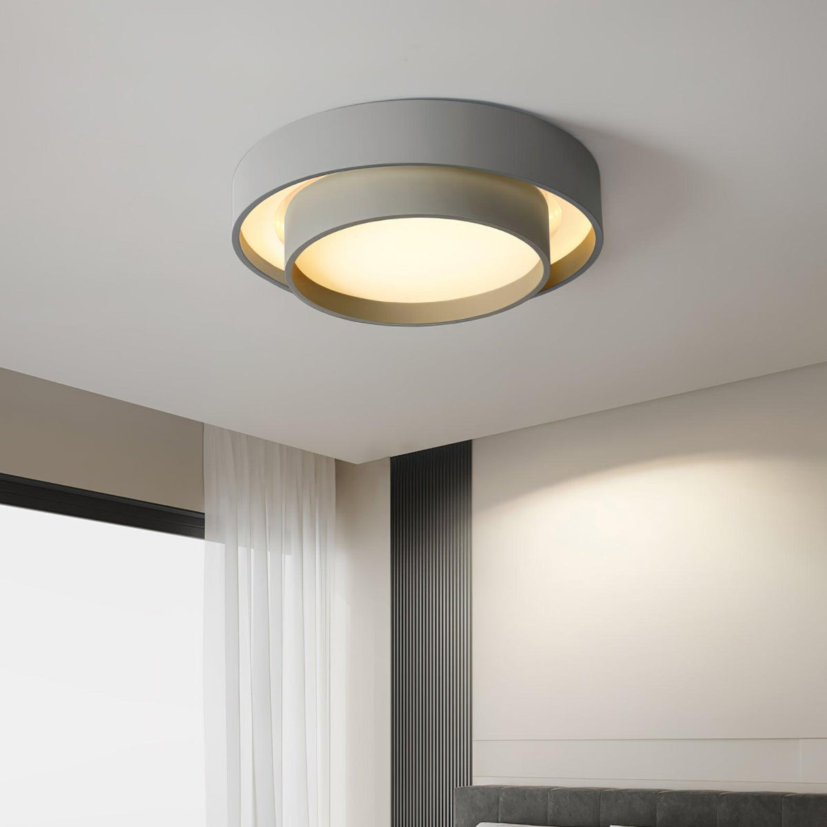 Grey wlip minimalist layered LED ceiling lamp providing soft illumination in a bedroom with a dark accent wall