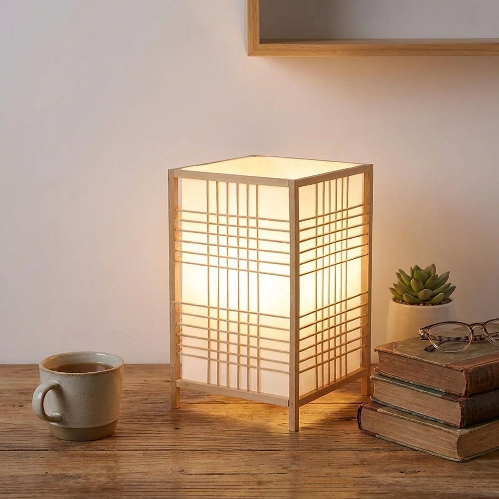 Xevlu bamboo shoji table lamp on a wood side table with candle and books
