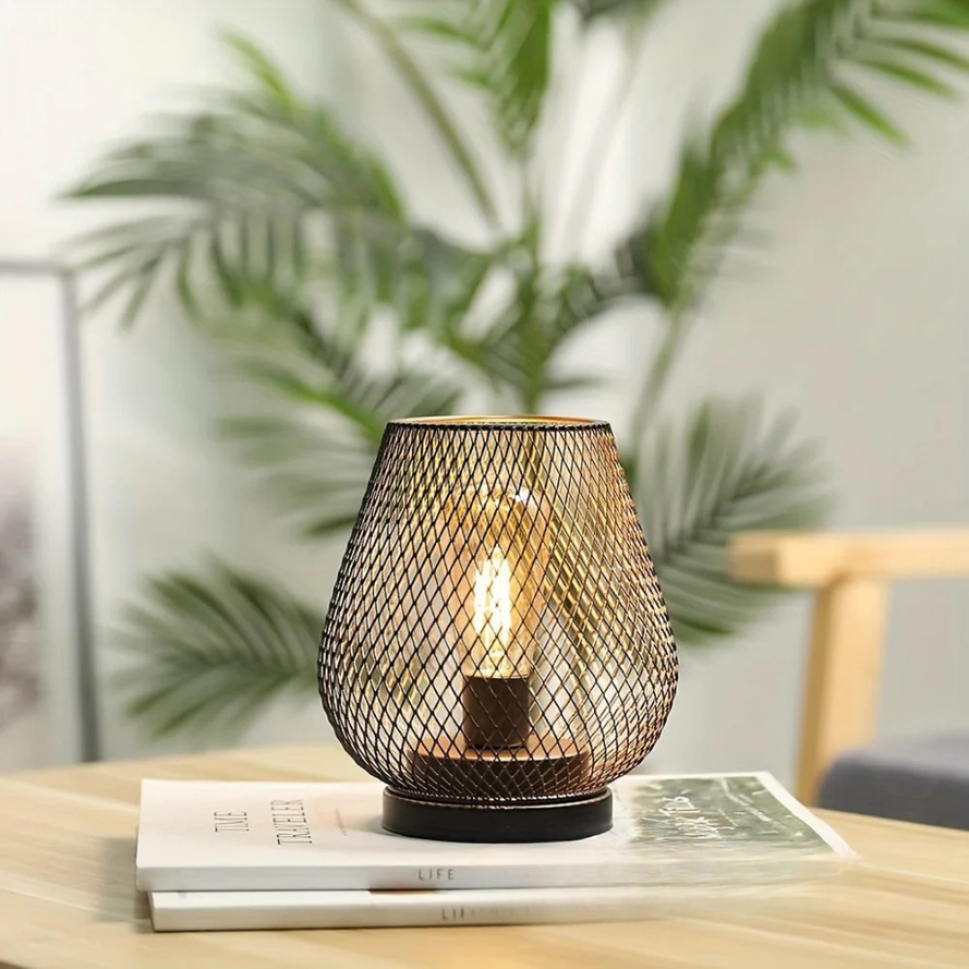 Single xolu portable industrial LED table lamp resting on a wooden side table in a bright, modern room with plants