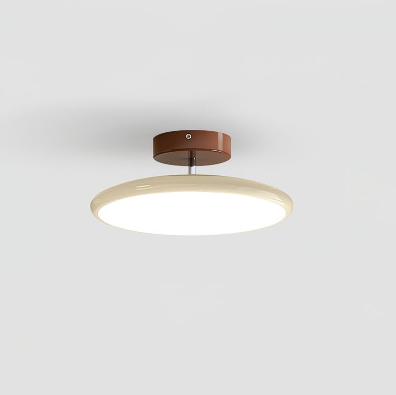 Small beige tilting LED xome ceiling fixture isolated on a clean background