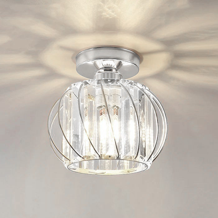 Sleek silver crystal globe yilo ceiling light illuminated to show a brilliant starburst reflection on the ceiling