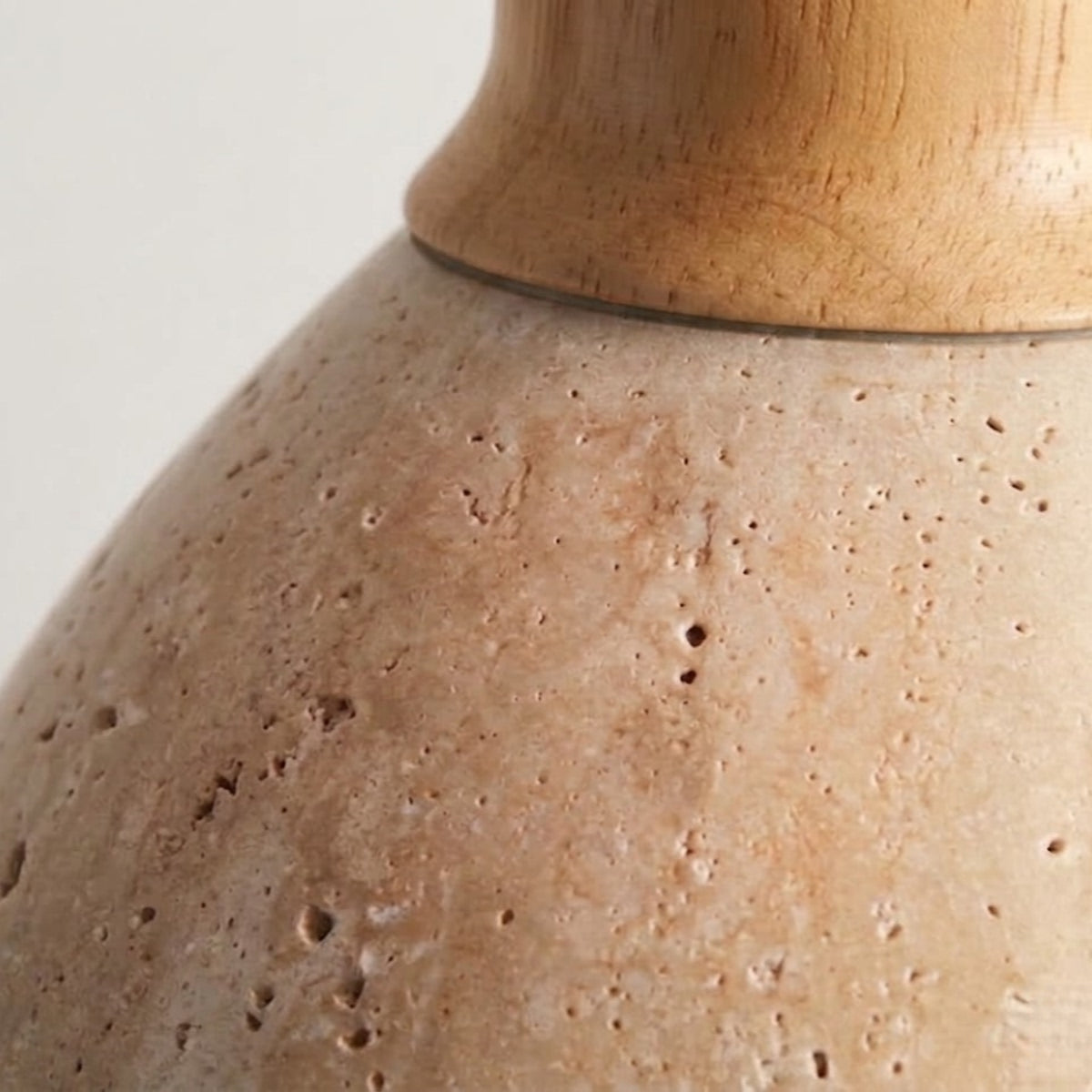 Close-up of the Yomzi pendant light's wood neck holder